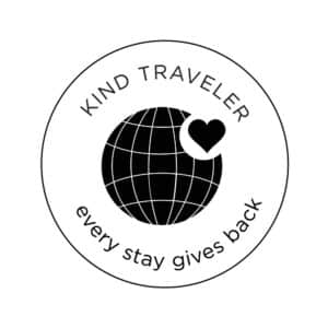 "Kind Traveler Every Stay gives back" Earth with heart in top right hand corner