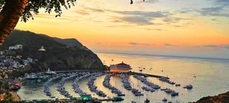 View of an ocean marina at dusk with soft purple and pink colors in the sky