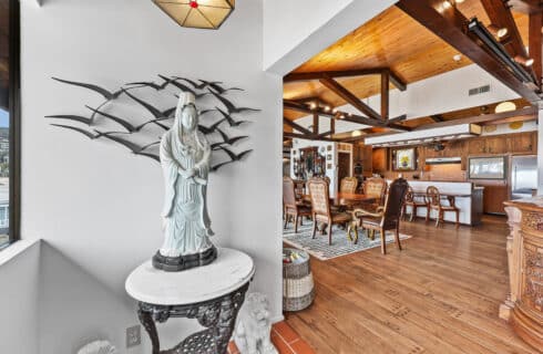 Entrance to penthouse featuring statue and dining area